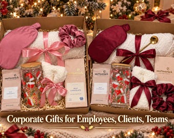 May include: Two gift boxes containing a white textured blanket, a satin sleep mask, a glass tumbler with a bamboo lid and holiday print, a pair of fuzzy socks, a satin scrunchie, and a Moonstruck milk chocolate bar in each set.