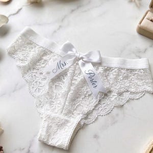 May include: A distressed wooden sign with the words "Welcome to our home" in white lettering. The sign has a rustic finish, ideal for adding a welcoming touch to a home's entrance.