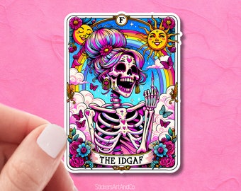 May include: A colorful sticker featuring a skeleton with a pink and blue hairstyle, wearing earrings and a necklace. The skeleton is giving the middle finger and is surrounded by rainbows, clouds, butterflies, and flowers. The text "THE IDGAF" is written on a banner below the skeleton. The sticker is from StickersArtAndCo.
