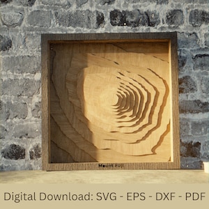 May include: A wooden framed artwork featuring a layered relief carving of Mount Fuji. The artwork is made of light-colored wood and has a detailed, textured appearance. The text "Mount Fuji" is at the bottom. The words "Digital Download: SVG - EPS - DXF - PDF" are at the bottom.