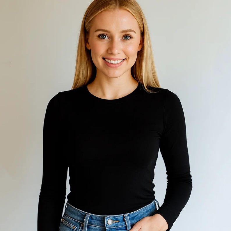 May include: A black long-sleeve shirt and blue jeans. The shirt has a crew neck and is made of a soft material. The jeans are a classic denim style.