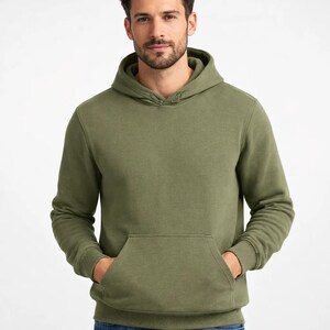 May include: Olive green hoodie with a kangaroo pocket and drawstring hood. The sweatshirt is a solid color and appears to be made of a soft, comfortable material. The hoodie is a casual style.