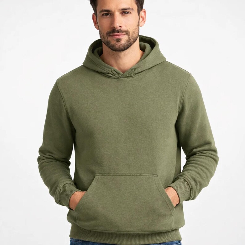 May include: Olive green hoodie with a kangaroo pocket and drawstring hood. The sweatshirt is a solid color and appears to be made of a soft, comfortable material. The hoodie is a casual style.