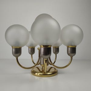 Könnte beinhalten: Ein Set aus drei Keramikbechern mit gesprenkelter, matter Oberfläche. Die Becher sind in Creme-, Hellgrau- und Dunkelgrautönen gehalten. Jeder Becher hat ein schlichtes, minimalistisches Design.