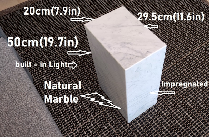 May include: A white marble cube with a built-in light. The cube measures 20 inches by 29.5 inches by 50 inches. The marble is natural and impregnated.