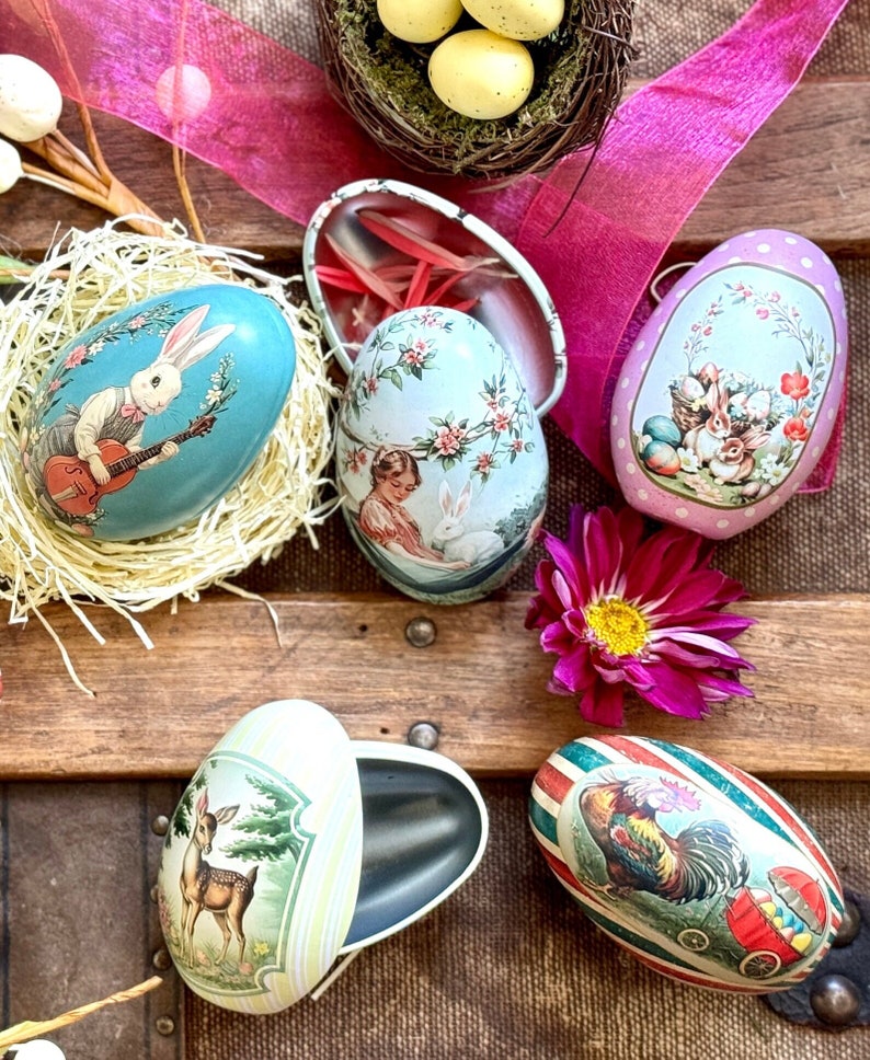 Vintage-Inspired Easter Egg Tins: A set of 10 reusable, fillable metal eggs, perfect for Easter gifts and hunts. Unique, collectible designs for festive decoration and family traditions. Ideal for sweets and surprises.