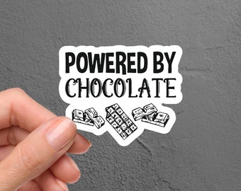 May include: White sticker with black text that reads "Powered by Chocolate" and a drawing of broken chocolate bars.