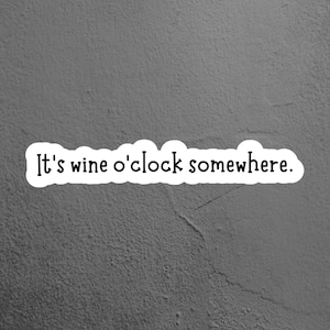 May include: A white sticker with black text on a gray textured background. The text reads "It's wine o'clock somewhere."
