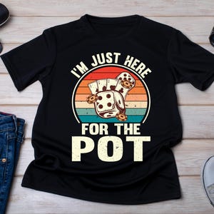 May include: Black t-shirt with a vintage-style graphic of dice and the text "I'm Just Here For The Pot".