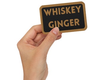 May include: A brown patch with black text that reads "WHISKEY GINGER"