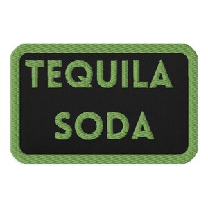May include: Green embroidered patch with black background. The patch says "Tequila Soda" in green letters.