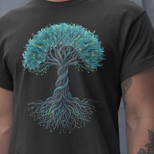 May include: Dark grey t-shirt with a detailed illustration of a tree. The tree's foliage is designed with a circuit board pattern in blue and green, creating a tech-inspired design. The trunk and roots are also visible.