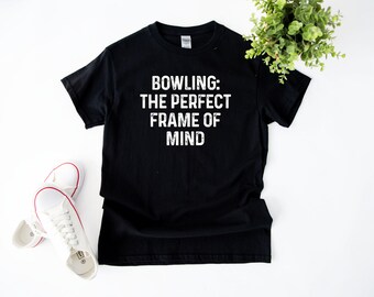 May include: Black t-shirt with white text that reads "Bowling: The Perfect Frame of Mind".