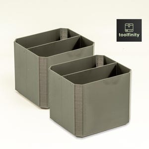 May include: Two gray plastic desk organizers with two compartments each. The organizers are made of a textured plastic and have a modern design.