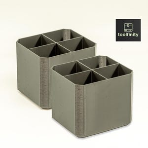 May include: Two gray plastic organizers with six compartments each. The organizers are made of a textured material and have a square shape.