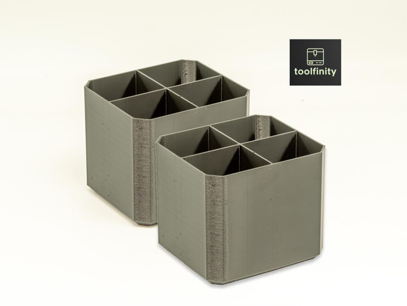 May include: Two gray plastic organizers with six compartments each. The organizers are made of a textured material and have a square shape.