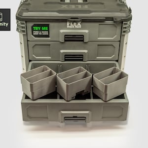 Puede incluir: Un sistema de almacenamiento de herramientas FLEX Stack Pack gris con tres cajones y tres contenedores de almacenamiento grises. La parte superior de la unidad tiene la palabra FLEX. Los cajones tienen asas. El texto "TRY ME" y "PUSH & CLICK SHUT TO LOCK" está en la parte delantera.