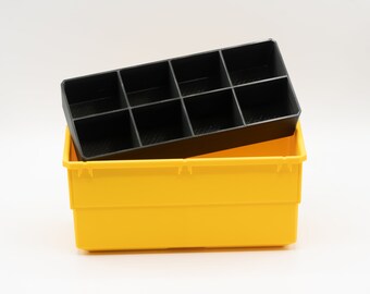 May include: A yellow plastic storage bin with a black, divided insert. The insert has eight compartments. The bin is rectangular and sits on a white background. The image is well-lit and shows the products clearly.