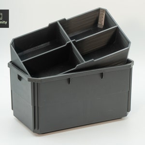 May include: A two-piece, dark gray storage organizer. The top piece has multiple compartments, and sits atop a larger, rectangular base. The logo "toolfinity" is in the upper left corner. The organizer is designed for efficient storage.