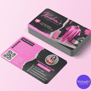 May include: A pile of business cards with rounded edges. The cards have a black and pink design with the text "Keisha's Creative Studio." One card shows a QR code and the text "Scan me & let's make something cutesy together!"