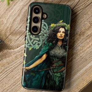 May include: A phone case with a green, black, and white design featuring a woman with long dark hair wearing a green and silver dress. The case has a Celtic knot design and a floral pattern.