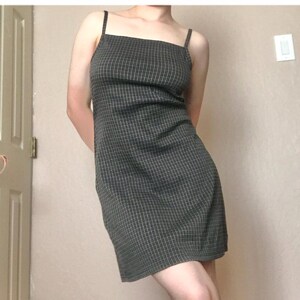 May include: A black and white checkered sleeveless dress with thin straps.