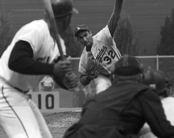 Sandy Koufax pitching to Willie Mays