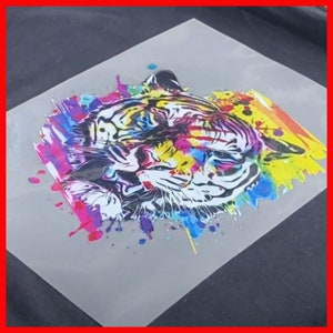 May include: A colorful tiger head illustration with a watercolor effect. The tiger is outlined in black and the background is a mix of pink, blue, yellow, and green.