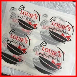 May include: Four white sheets of paper with a black and red logo that says "Louie's Kitchen" with a chef's hat and a wok with flames.