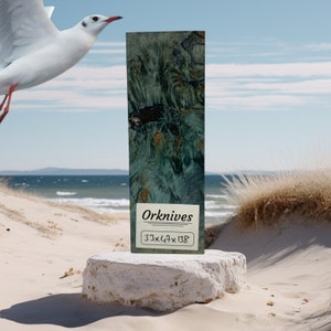 May include: A close-up of a piece of wood with a blue and green marbled pattern. The wood is labeled "Orknives 33x64x138".