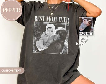 May include: Dark gray t-shirt with the text "BEST MOM EVER" above a black and white photo of a mother and child. The shirt has a vintage look and a small photo upload option.
