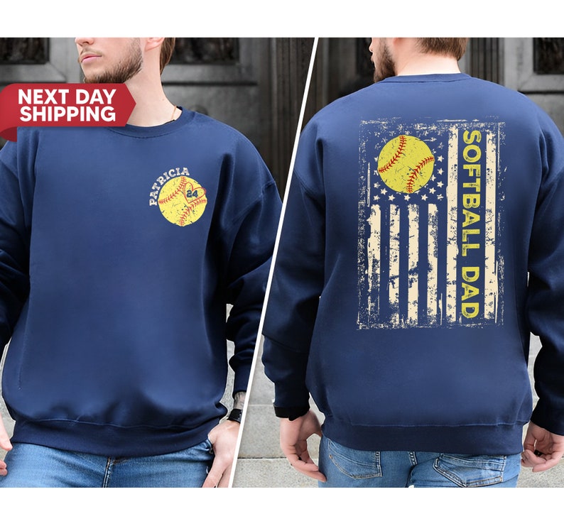 May include: Navy blue sweatshirt with a distressed American flag design and the text "Softball Dad" on the back. The front of the sweatshirt features a softball with the text "Patricia 24" on it.