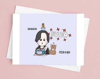 May include: A birthday greeting card with a cartoon illustration of a person holding a cake. The card features the text "SUGA" and Korean text. A cartoon cat wearing a party hat is also included in the design.