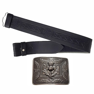 May include: Black leather belt with embossed Celtic knotwork and a silver-coloured buckle featuring a thistle design. The belt is shown unfastened, displaying the intricate details of the buckle and the belt's texture.