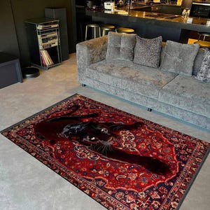 May include: A rectangular area rug featuring a traditional red and dark blue floral pattern with a large, realistic black panther illustration stretched across the centre. The rug has a dark grey border and is positioned on a light grey floor.