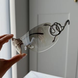 Transparent lenses snake silver frame futuristic sunglasses