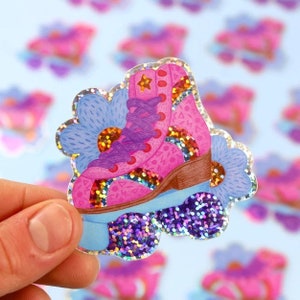 May include: A pink roller skate with purple laces and a gold star on the toe. The skate is surrounded by blue flowers and glitter.