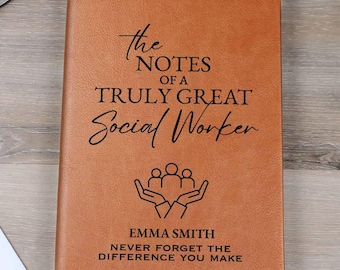 May include: A brown leather journal with the text "The Notes of a Truly Great Social Worker" and the name "Emma Smith". The journal has a ribbon bookmark and a graphic of hands holding people. A pen and glasses are on the side.