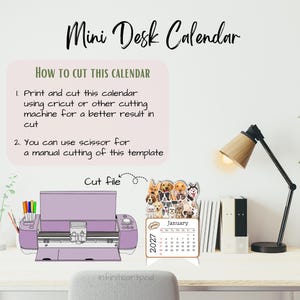 May include: A digital template for a 2027 mini desk calendar featuring illustrations of various dog breeds. The graphic includes instructions for cutting with a machine or scissors, a purple cutting machine illustration, and a calendar page for January.