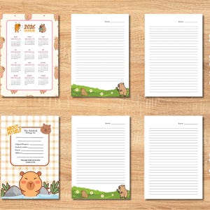 Pu&ograve; includere: Un quaderno con un calendario 2026, pagine a righe e a puntini e una sezione "Su di me". Le pagine presentano illustrazioni di orsi e una combinazione di colori marrone chiaro e rosa. Il quaderno &egrave; progettato per uso personale.