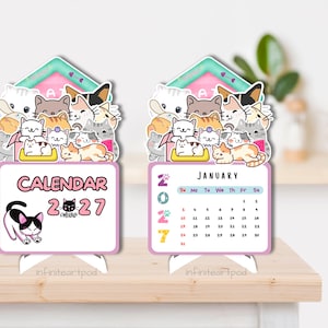 May include: Two standing desk calendars for 2027 featuring a group of illustrated cats at the top. The left calendar displays the text CALENDAR 2027 with a black and white cat. The right calendar shows the month of January with a grid of dates.