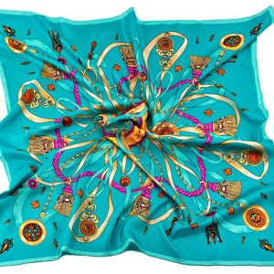 Dark turquoise silk scarf in a classic pattern of ribbons and medallions in pink, navy blue and gold