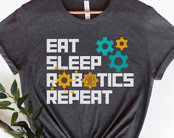 Könnte beinhalten: Ein dunkelgraues T-Shirt mit dem Text "Eat Sleep Robotics Repeat" in Weiß. Der Text ist von bunten Zahnrädern umgeben.