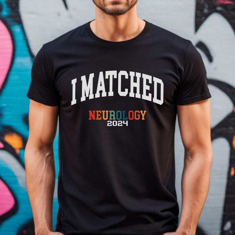 May include: A black t-shirt with white text that reads "I MATCHED NEUROLOGY 2024". The word "NEUROLOGY" is in rainbow colours.