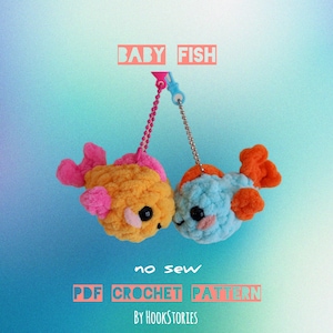 May include: Two crocheted baby fish toys, one yellow and one blue, with orange fins, hanging from a blue and white string. The text "BABY FISH" is above the toys, and "no sew PDF CROCHET PATTERN by HOOKSTORIES" is below.