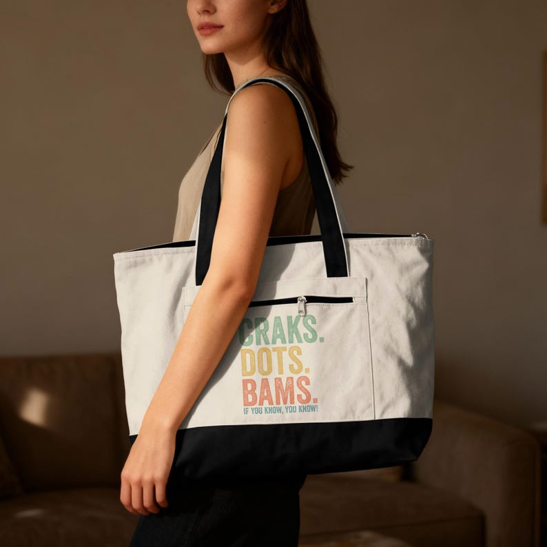 Cream tote bag with "Craks. Dots. Bams. If you know, you know!" text.