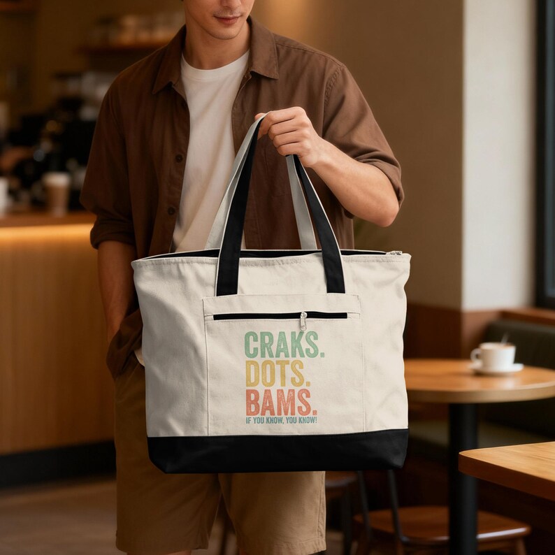 Canvas tote bag with "CRAKS. DOTS. BAMS." text and small pocket.