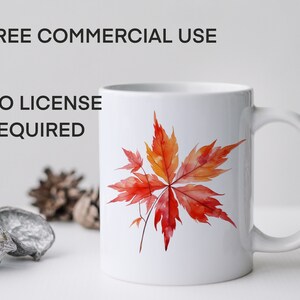 May include: White ceramic mug with a red and orange watercolor maple leaf design. The mug has a black handle and the text "FREE COMMERCIAL USE NO LICENSE REQUIRED" is printed on the mug.