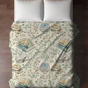 May include: A white duvet cover with a pattern of stacked books and floral sprigs. The books are illustrated with watercolor-style drawings of open pages.