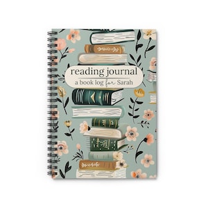 May include: A blue reading journal with a stack of books and floral designs. The journal says "reading journal, a book log for Sarah".